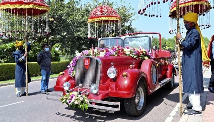 Groom's grand entry on a flower-decorated buggy at night